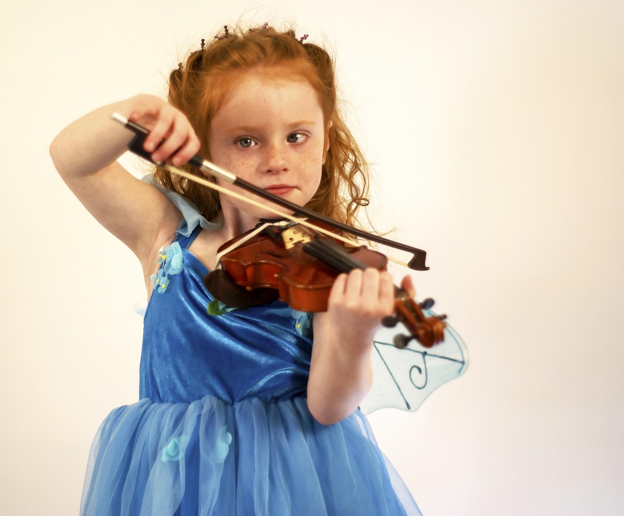 A young girl playing the violin